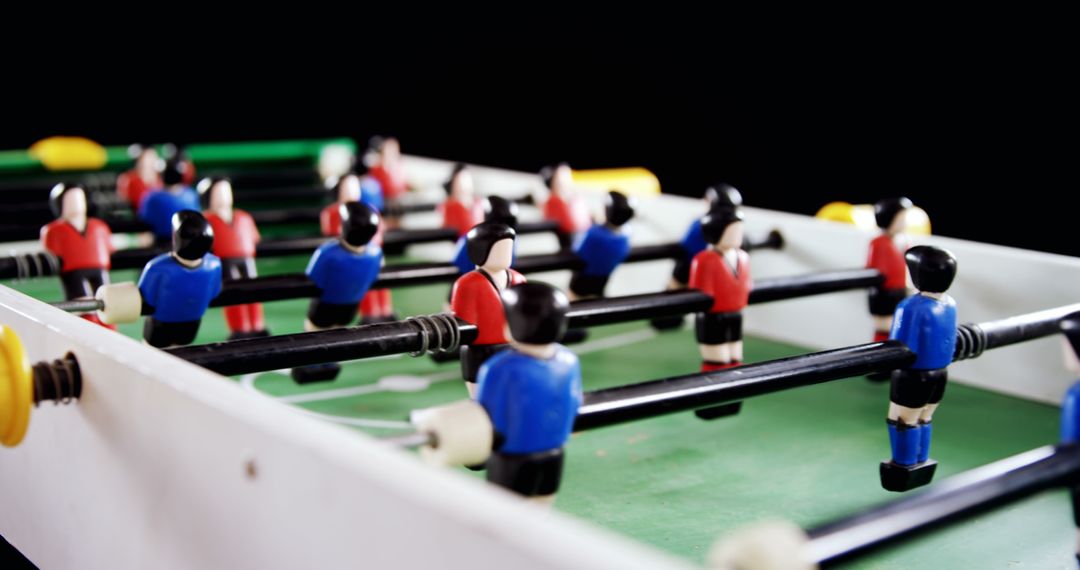 Close-up View of Foosball Table Game with Miniature Players