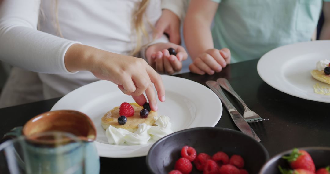 Children Decorating Pancakes with Fresh Berries for Breakfast - Free Images, Stock Photos and Pictures on Pikwizard.com