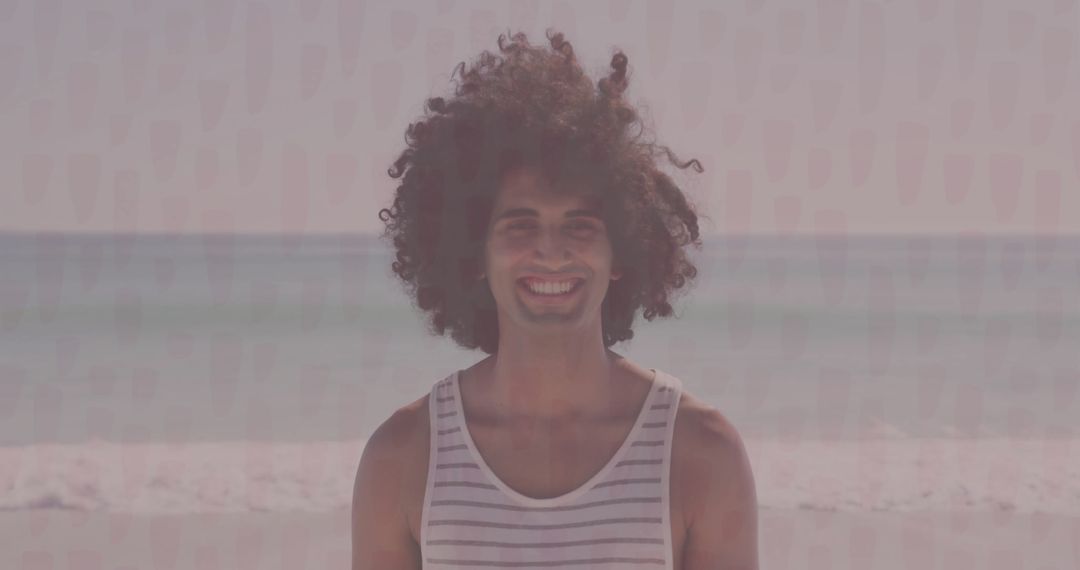 Man Enjoying Calm Beach Vibe in Striped Tank Top at Shoreline