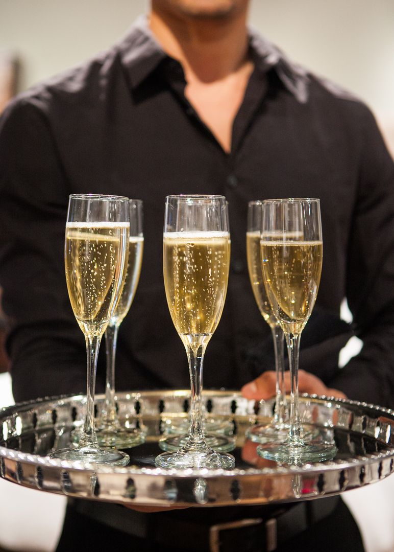 Waiter Serving Champagne Flutes at Elegant Event