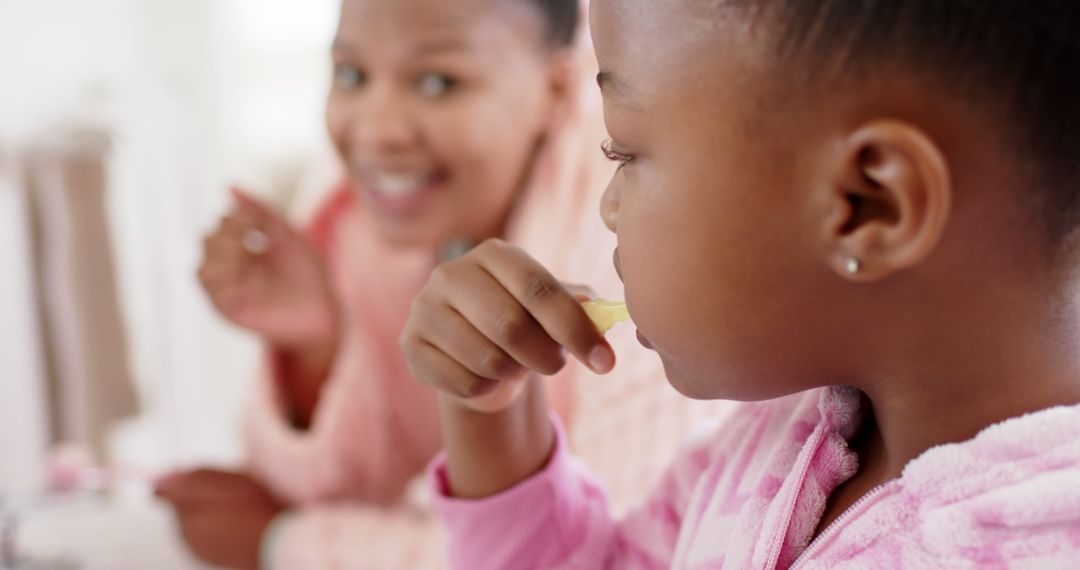 Mother Teaching Daughter to Brush Teeth Together - Free Images, Stock Photos and Pictures on Pikwizard.com