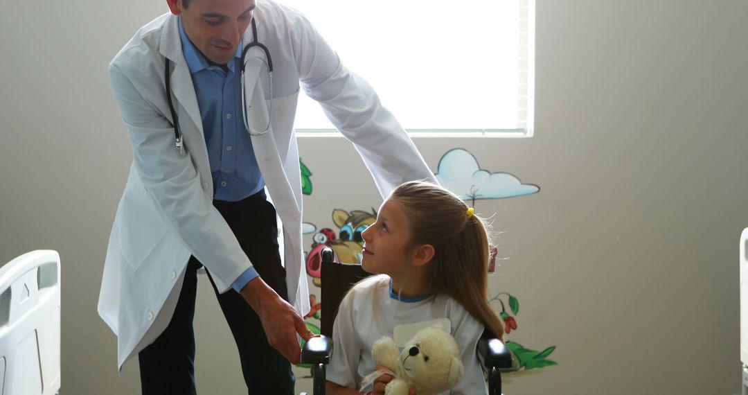 Doctor Interacting with Young Girl in Wheelchair at Hospital - Free Images, Stock Photos and Pictures on Pikwizard.com