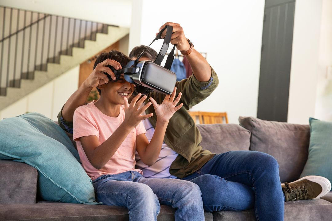 Father Introducing Son to Virtual Reality Experience at Home