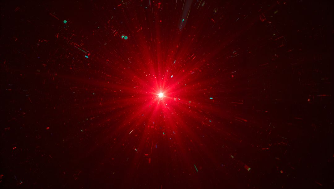Radiating Red Starburst with Radial Beams and Teal Particle Flecks in Dark Void