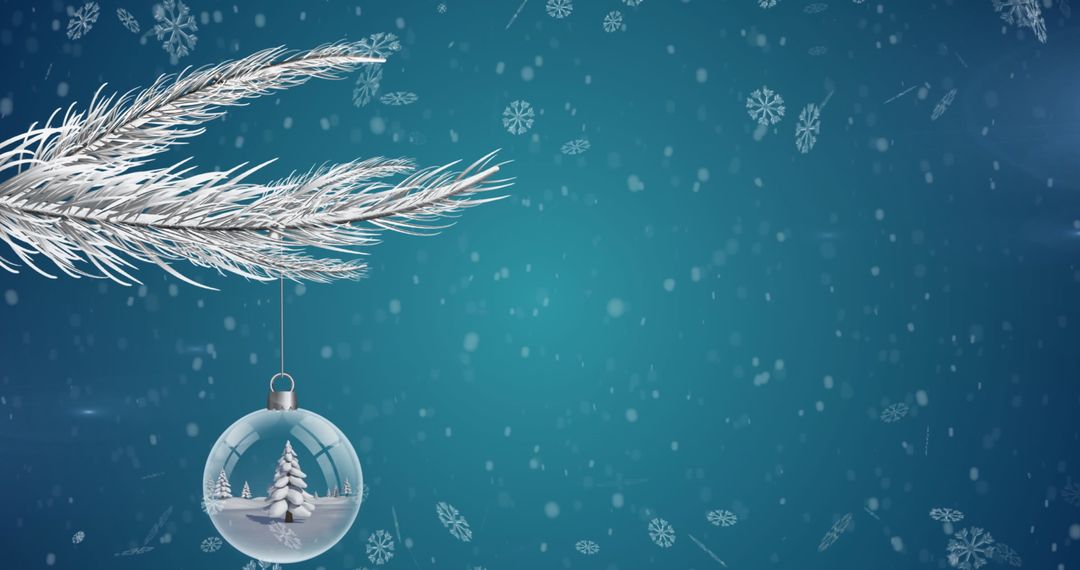 Christmas Bauble with Tree Hanging from Snowy Branch Against Blue Background