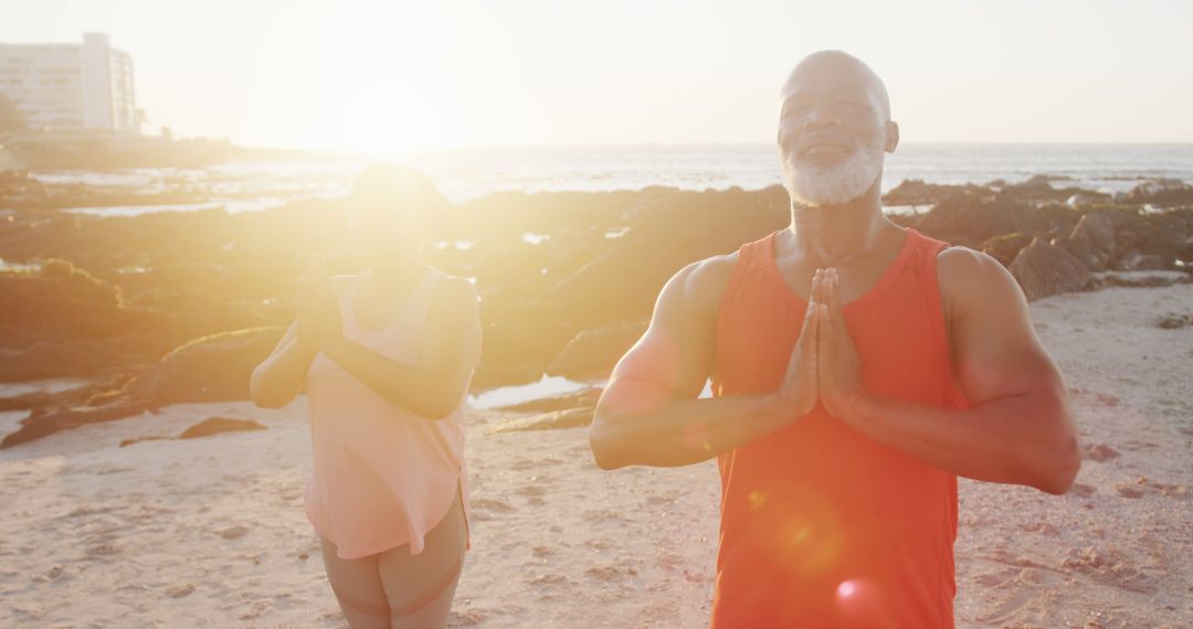 Senior Couple Doing Yoga at Sunset Beach, Relaxing and Meditating - Free Images, Stock Photos and Pictures on Pikwizard.com