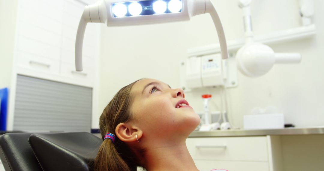 Young Girl Waiting for Dental Examination in Dental Chair - Free Images, Stock Photos and Pictures on Pikwizard.com