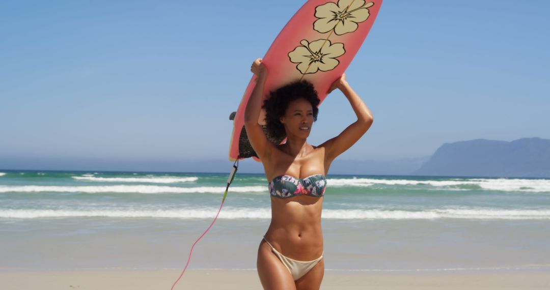 Woman Carrying Surfboard on Sunny Beach Ready for Surfing - Free Images, Stock Photos and Pictures on Pikwizard.com