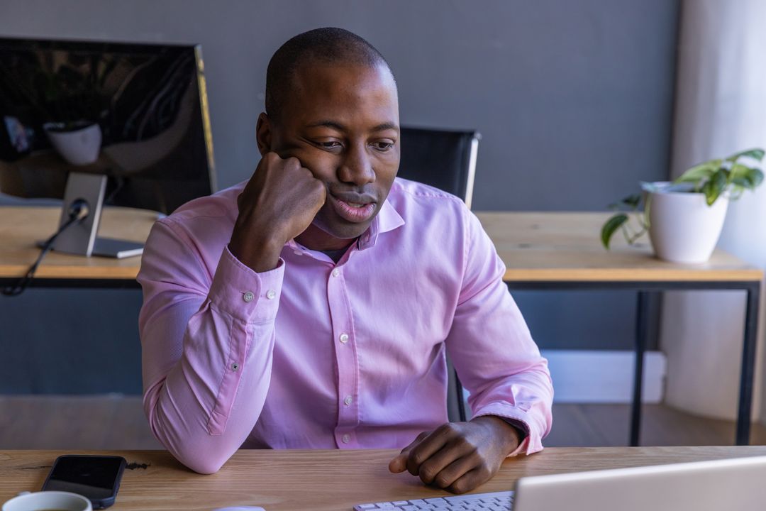 Focused Professional Working Remotely on Laptop in Home Office