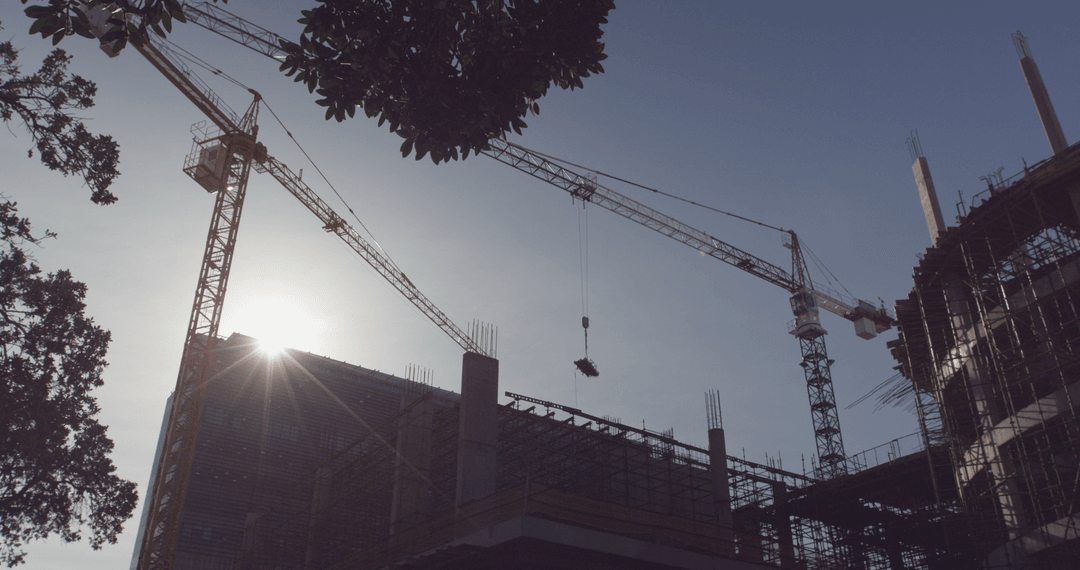 Transparent Silhouette of Construction Cranes Against Clear Sky