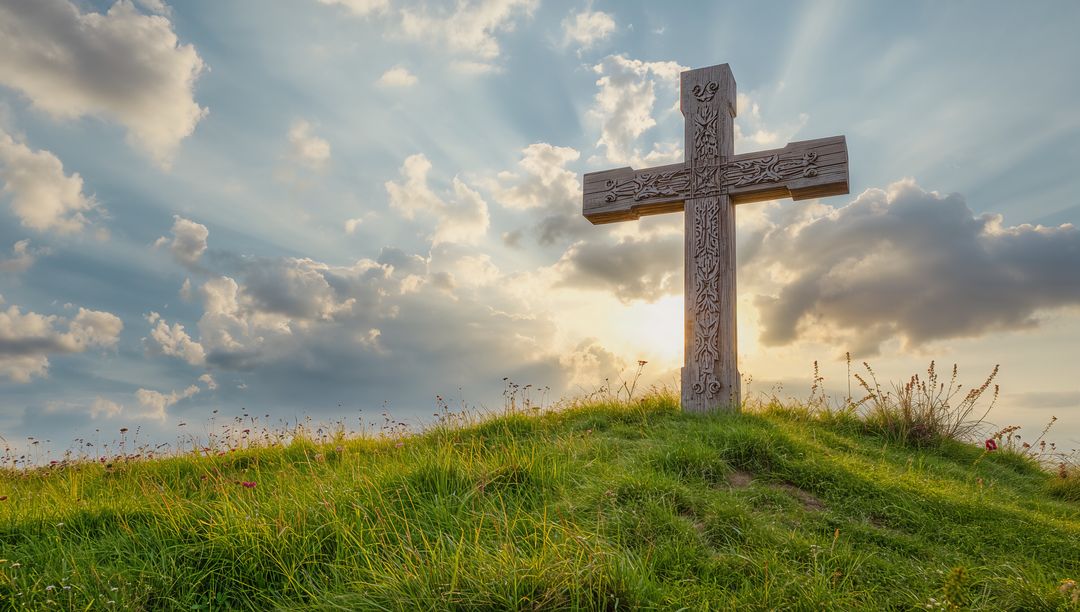 Standing Carved Cross on Hilltop Meadow with Sun Ray Illumination