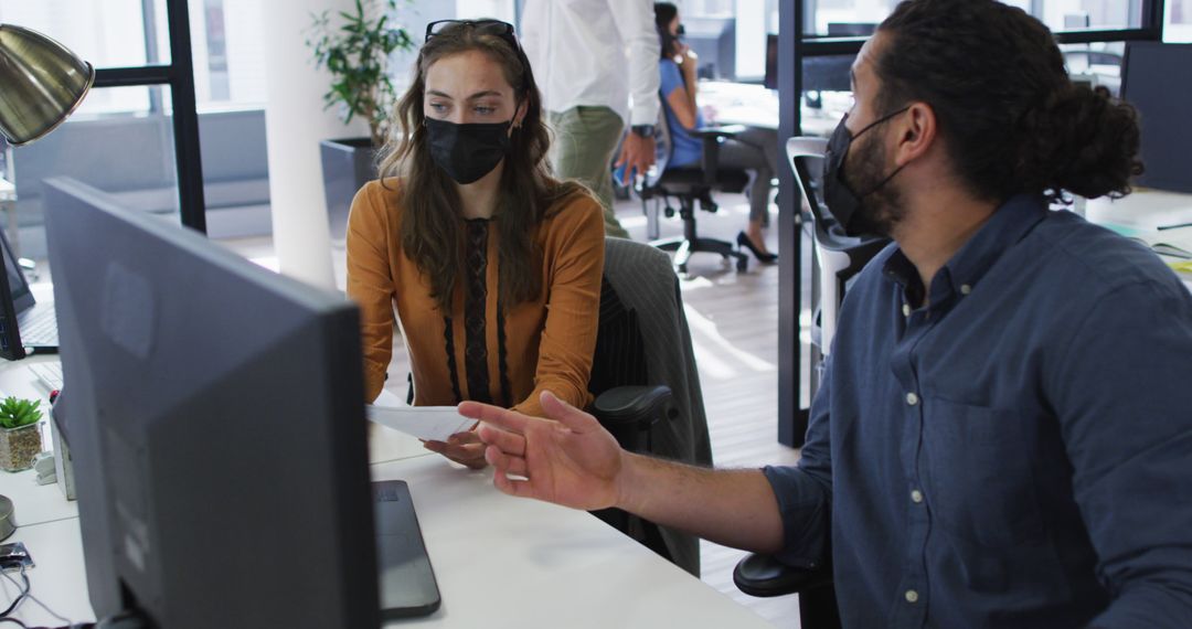 Coworkers Collaborating with Face Masks at Office Desk - Free Images, Stock Photos and Pictures on Pikwizard.com