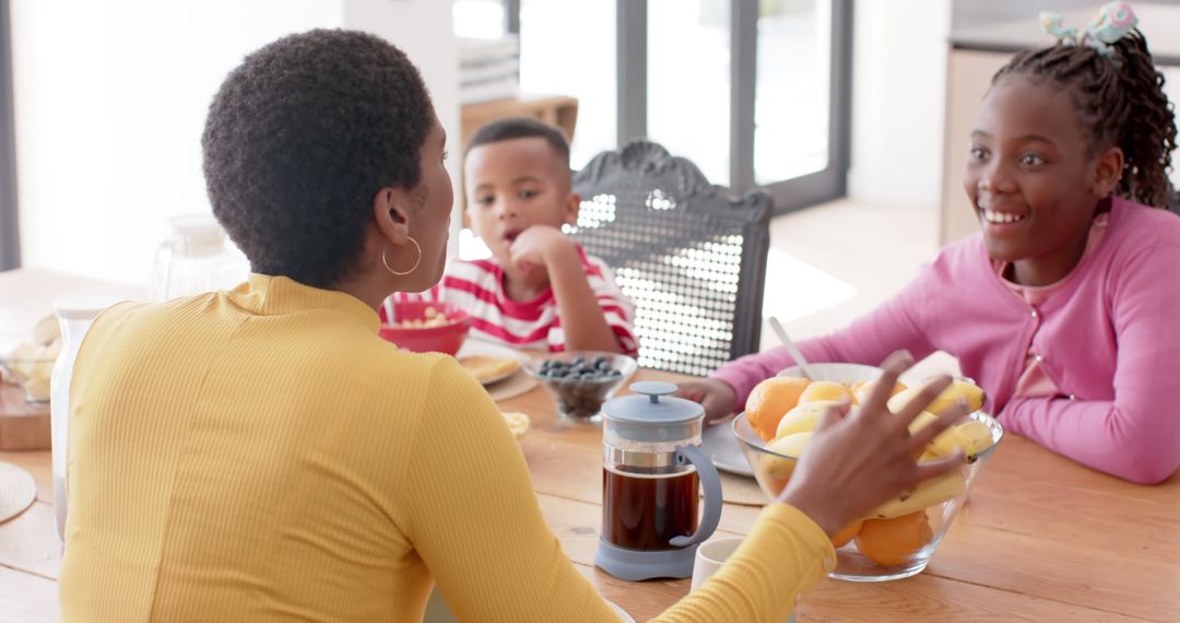 Mother with Two Children Enjoying Breakfast at Home - Free Images, Stock Photos and Pictures on Pikwizard.com