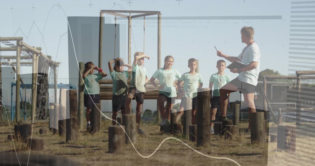 Group of Children Balancing on Obstacle Course with Coach Direction