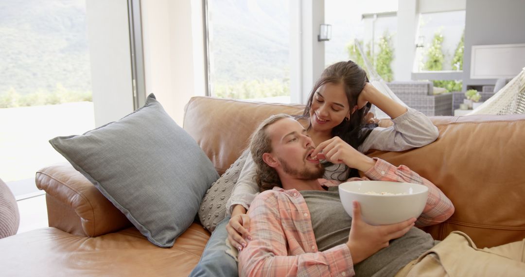 Cozy Couple Enjoying Movie Time with Popcorn at Home