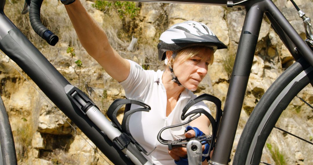 Female Cyclist Repairing Bike Outdoors - Free Images, Stock Photos and Pictures on Pikwizard.com