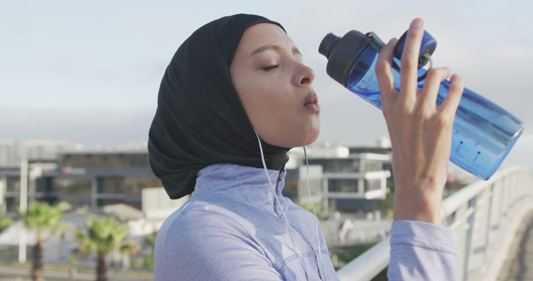 Young Muslim Woman Drinking Water After Workout - Free Images, Stock Photos and Pictures on Pikwizard.com