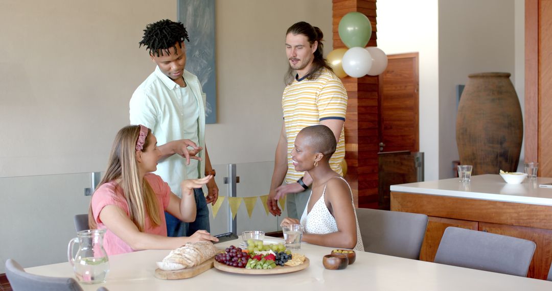 Friends Socializing at Home Eating Snacks and Interacting Joyfully