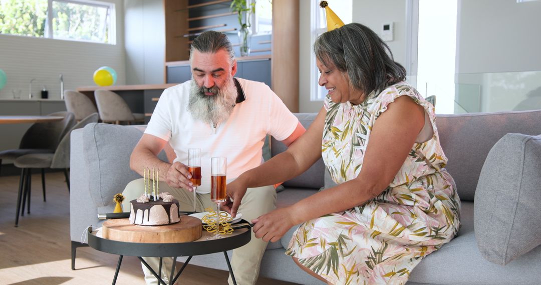 Senior Couple Celebrating Anniversary with Cake and Champagne at Home