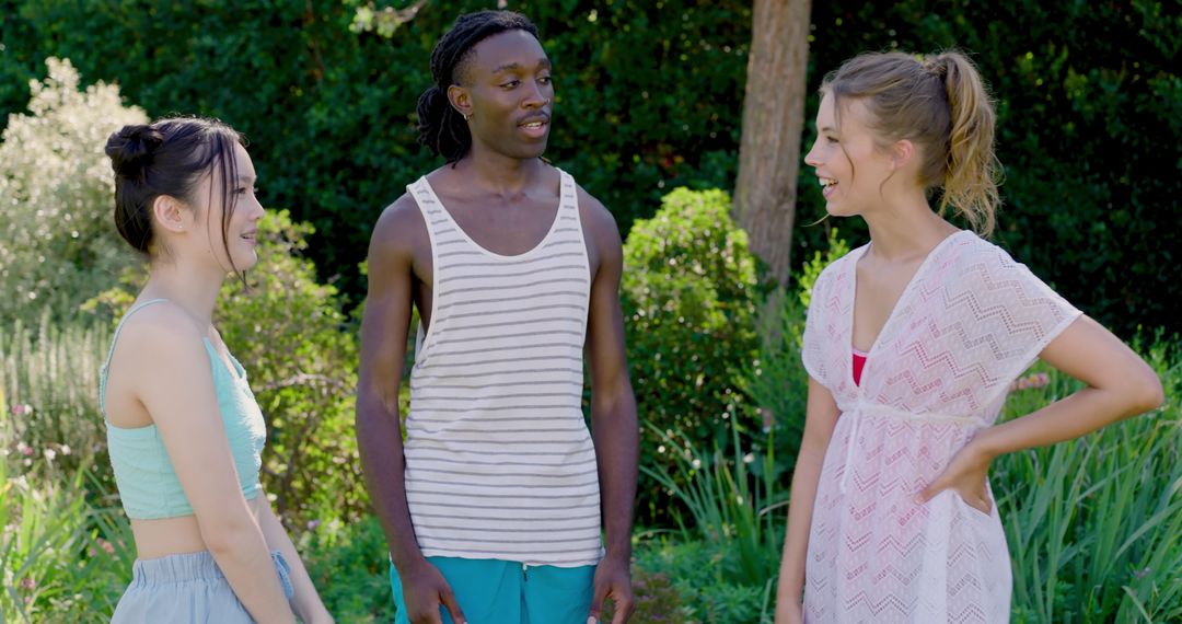 Diverse Friends Relaxing and Chatting in Lush Summer Garden