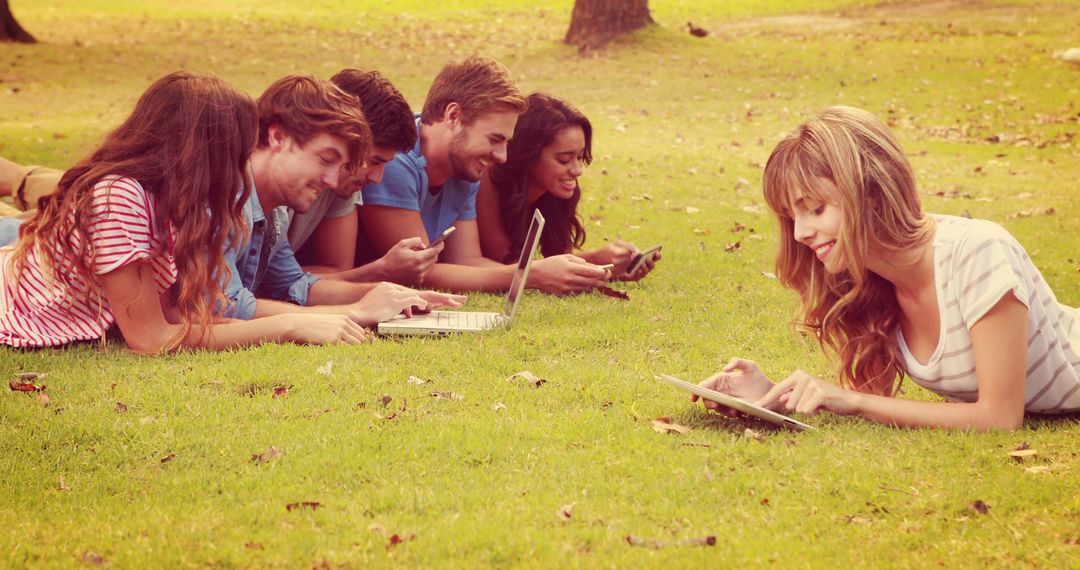 Group of Friends Relaxing on Grass with Technology - Free Images, Stock Photos and Pictures on Pikwizard.com