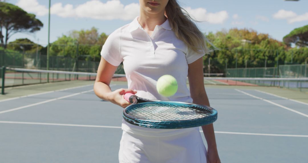 Female Tennis Player Practicing Ball Control on Sunny Court - Free Images, Stock Photos and Pictures on Pikwizard.com