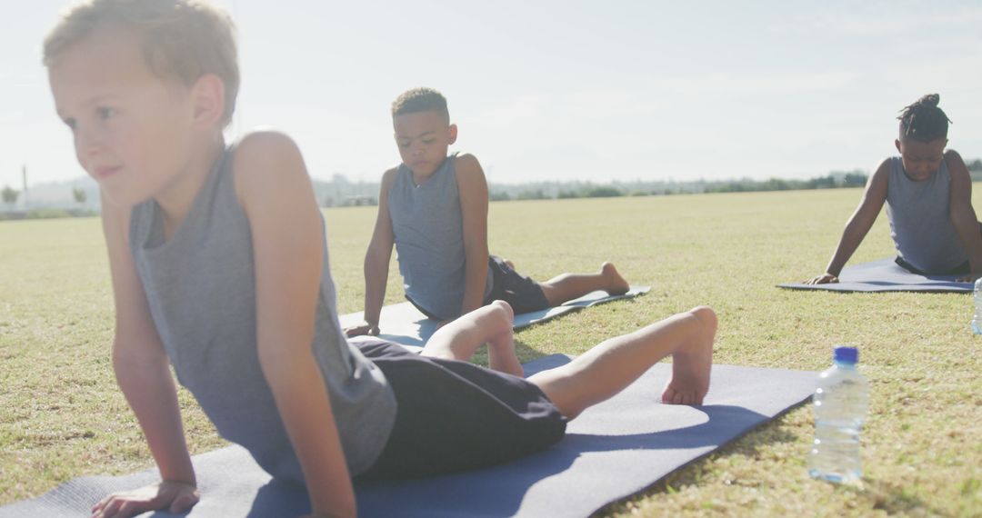 Diverse Group of Boys Doing Yoga in Park - Free Images, Stock Photos and Pictures on Pikwizard.com