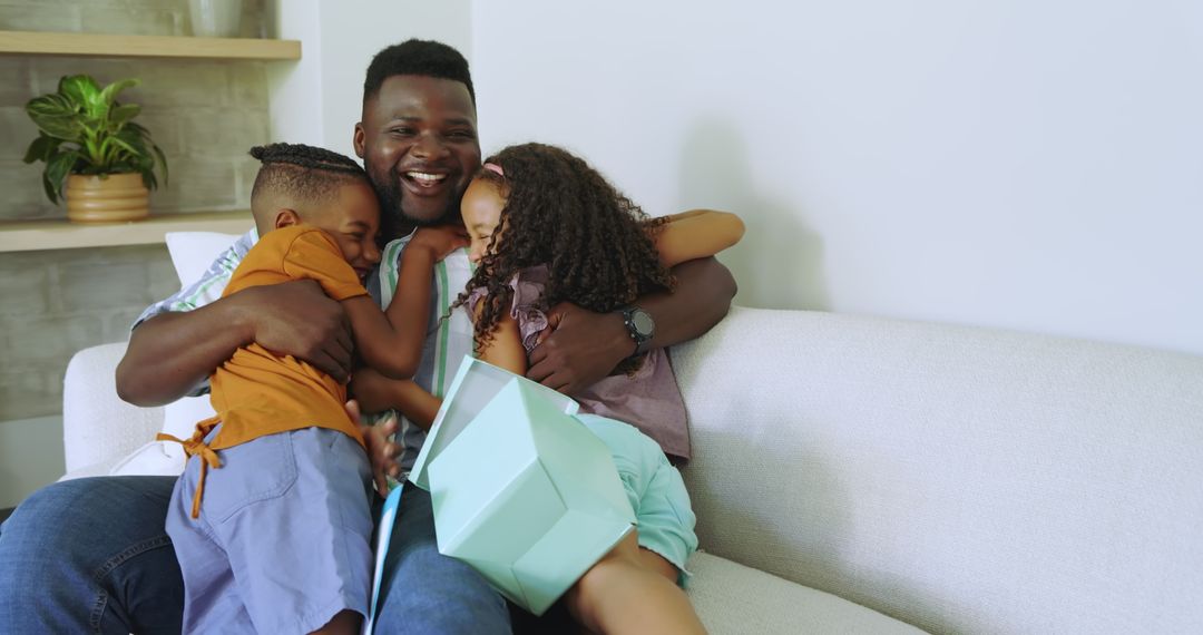 Happy Family Bonding on Sofa with Gift