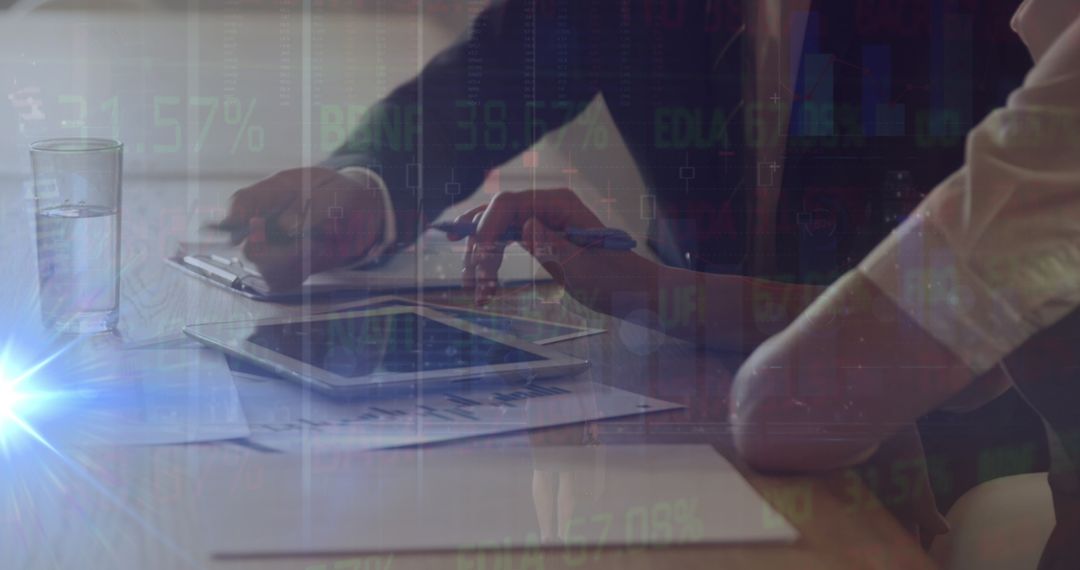 Business Professionals Analyzing Financial Data with Tablet and Documents