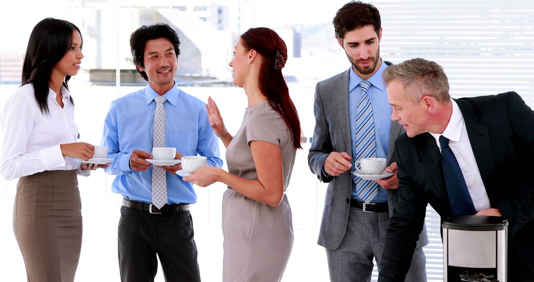 Diverse Colleagues Talking and Enjoying Coffee Break at Office - Free Images, Stock Photos and Pictures on Pikwizard.com