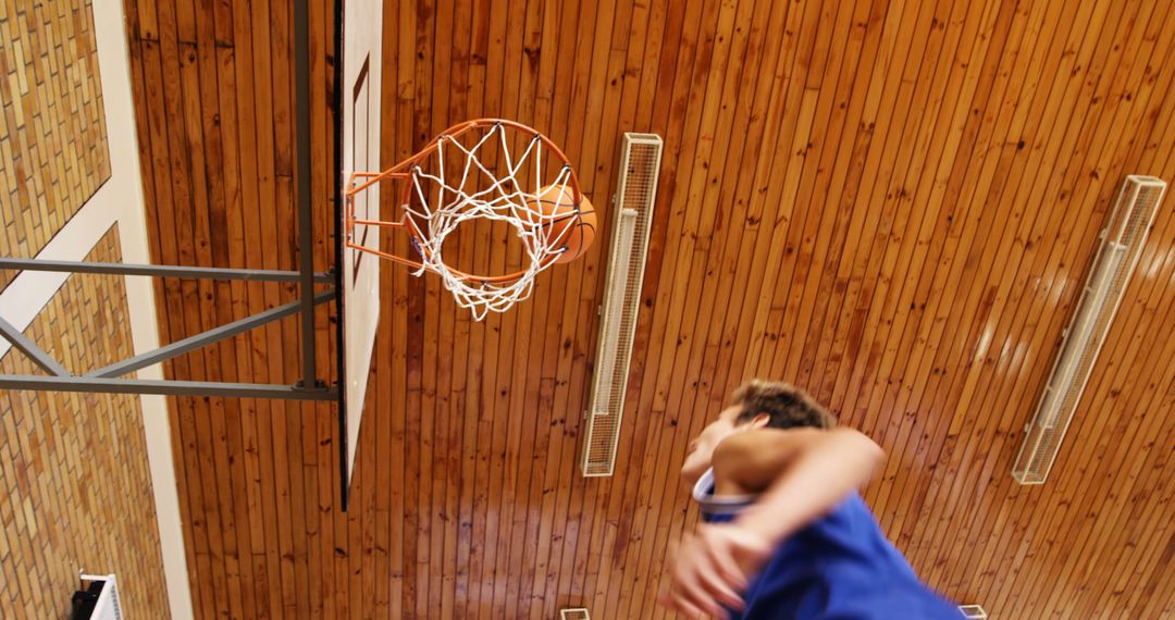 Basketball Player Dunking Ball in Indoor Gym - Free Images, Stock Photos and Pictures on Pikwizard.com