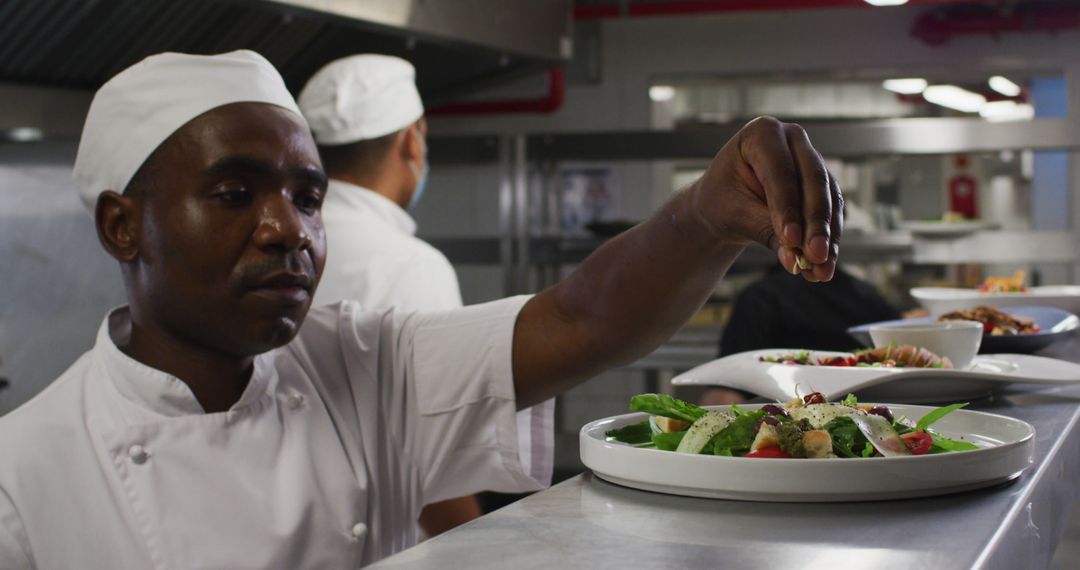 African American Chef Plating Dish in Professional Restaurant Kitchen - Free Images, Stock Photos and Pictures on Pikwizard.com