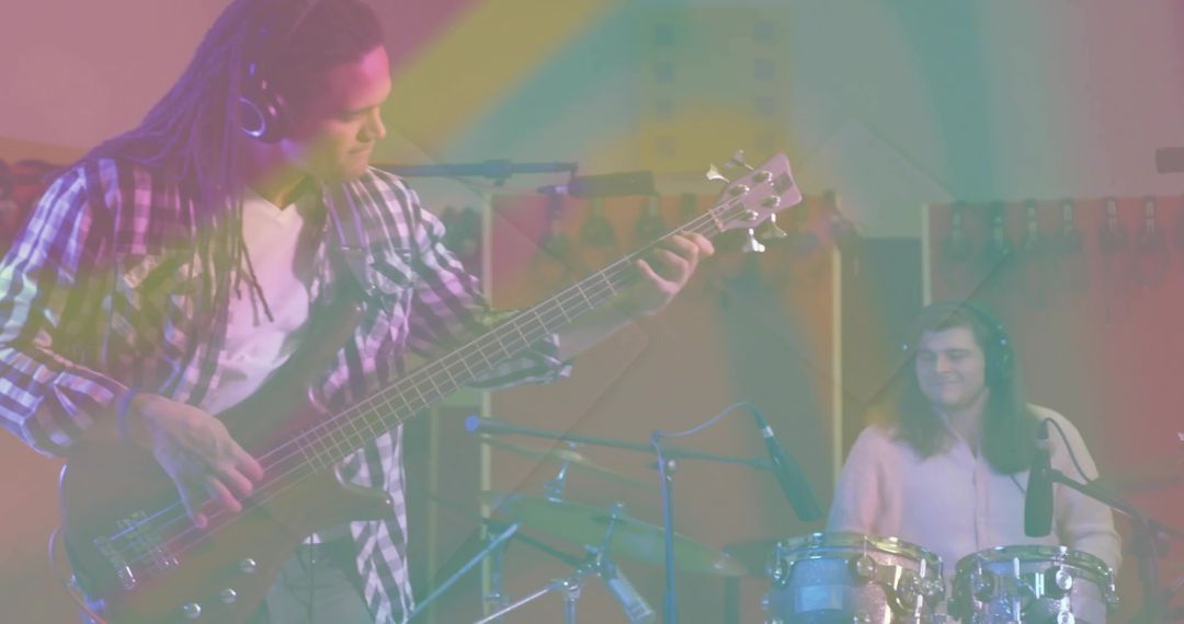 Bassist and Drummer Collaborating in Studio Session with Color Effects