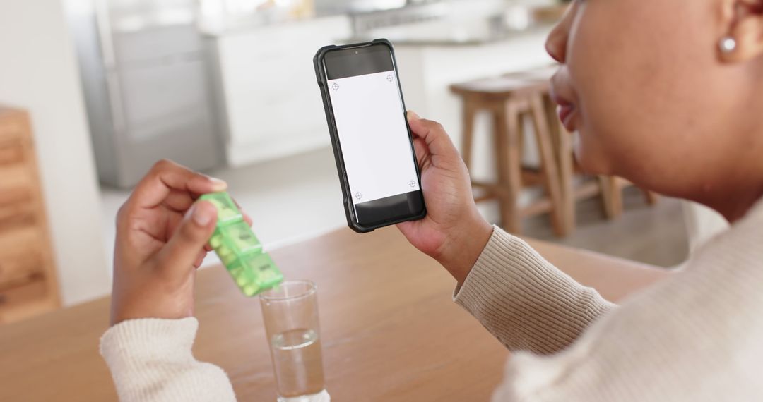 Woman Using Smartphone App to Track Medication Dosage at Home - Free Images, Stock Photos and Pictures on Pikwizard.com