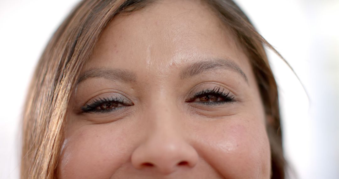 Close-Up of Woman Smiling with Eyes Looking Forward - Free Images, Stock Photos and Pictures on Pikwizard.com