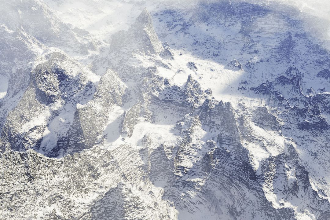 Aerial View of Snow-Covered Mountain Peaks in Winter - Free Images, Stock Photos and Pictures on Pikwizard.com