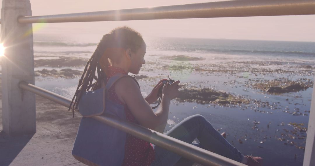 Moment Capture Enthusiast Framing Scenic Ocean View at the Pier