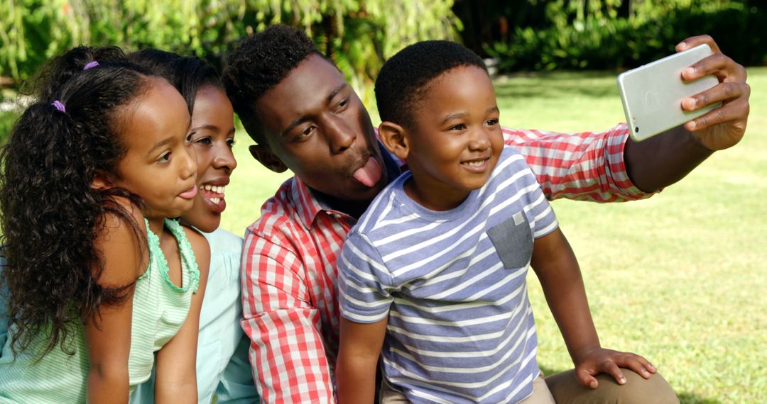 Happy African American Family Taking Selfie at Park - Free Images, Stock Photos and Pictures on Pikwizard.com