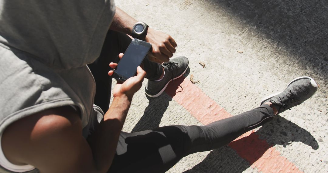 Athlete Checking Smartphone during Outdoor Workout - Free Images, Stock Photos and Pictures on Pikwizard.com