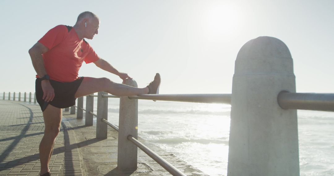 Senior Man Stretching By Ocean During Morning Jog - Free Images, Stock Photos and Pictures on Pikwizard.com