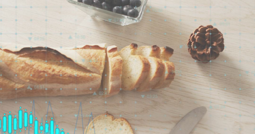 Rustic sliced baguette on wood table with berry bowl pinecone knife turquoise overlay
