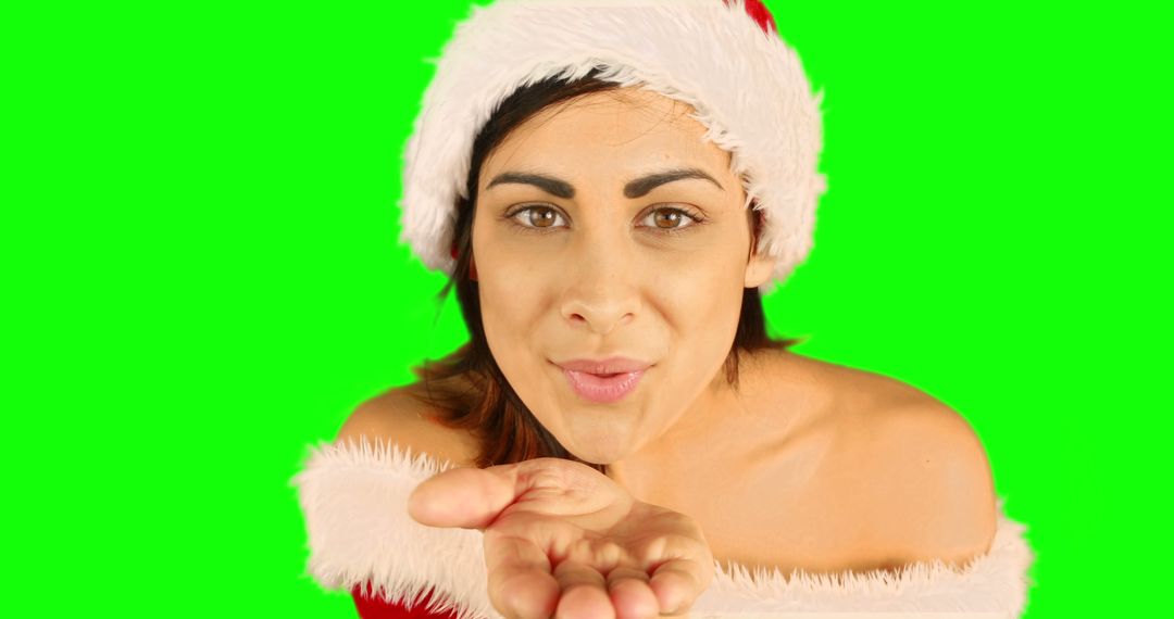 Woman in Santa Hat Blowing Kiss on Green Screen Background - Free Images, Stock Photos and Pictures on Pikwizard.com