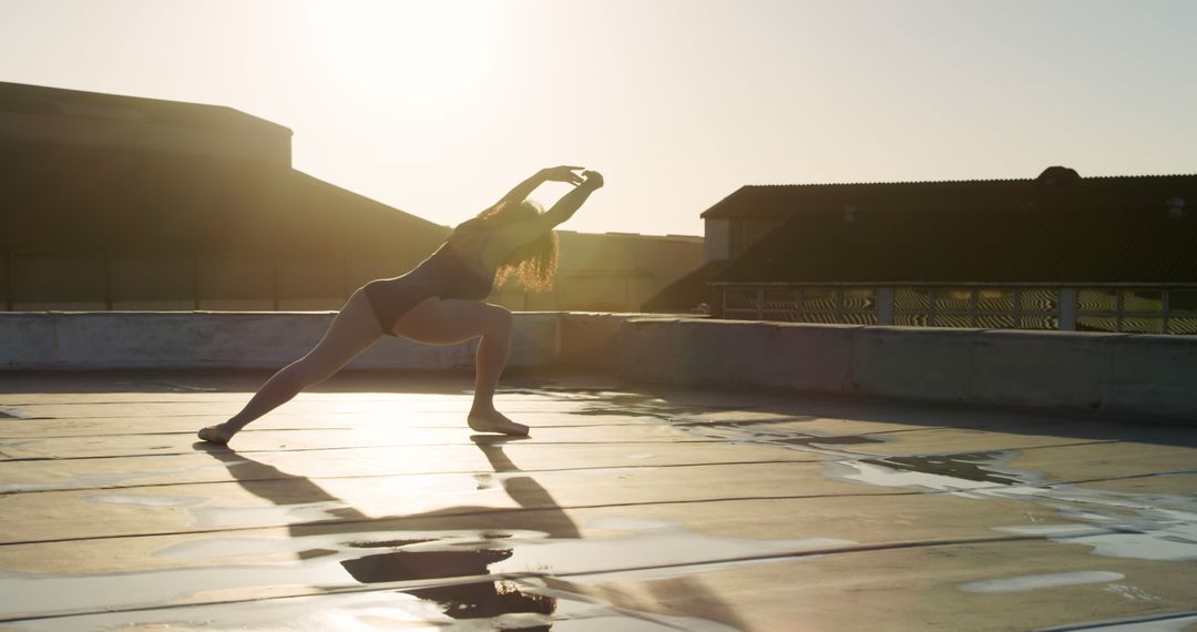 Woman Practicing Yoga Outdoors During Sunrise in Urban Area - Free Images, Stock Photos and Pictures on Pikwizard.com