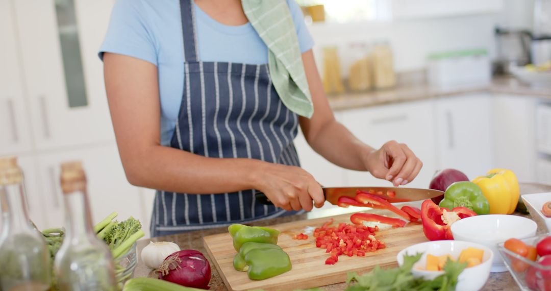 Woman Chopping Peppers in Modern Kitchen - Free Images, Stock Photos and Pictures on Pikwizard.com