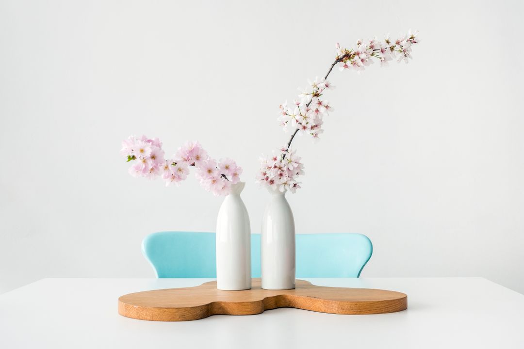 Minimalist Decor with Sakura Blossoms in White Vases on Wooden Stand - Free Images, Stock Photos and Pictures on Pikwizard.com