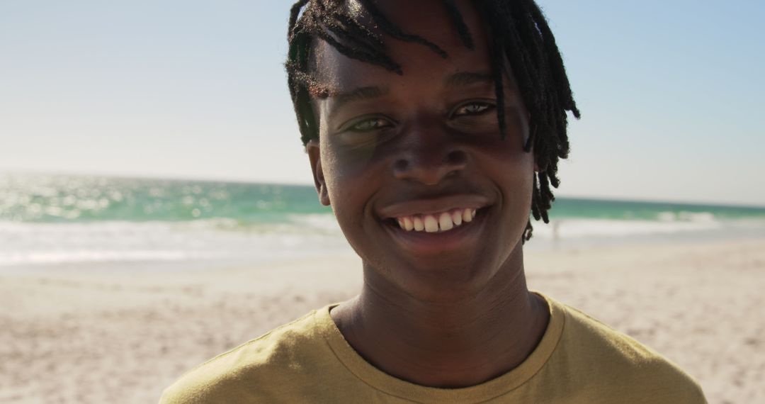 Smiling Young Man Enjoying Beach View on Sunny Day