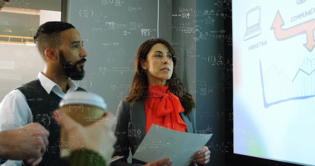 Business Professionals Analyzing Presentation Data in Modern Office