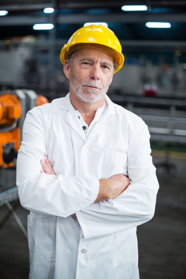 Portrait of factory engineer standing with his arms crossed - Free Images, Stock Photos and Pictures on Pikwizard.com