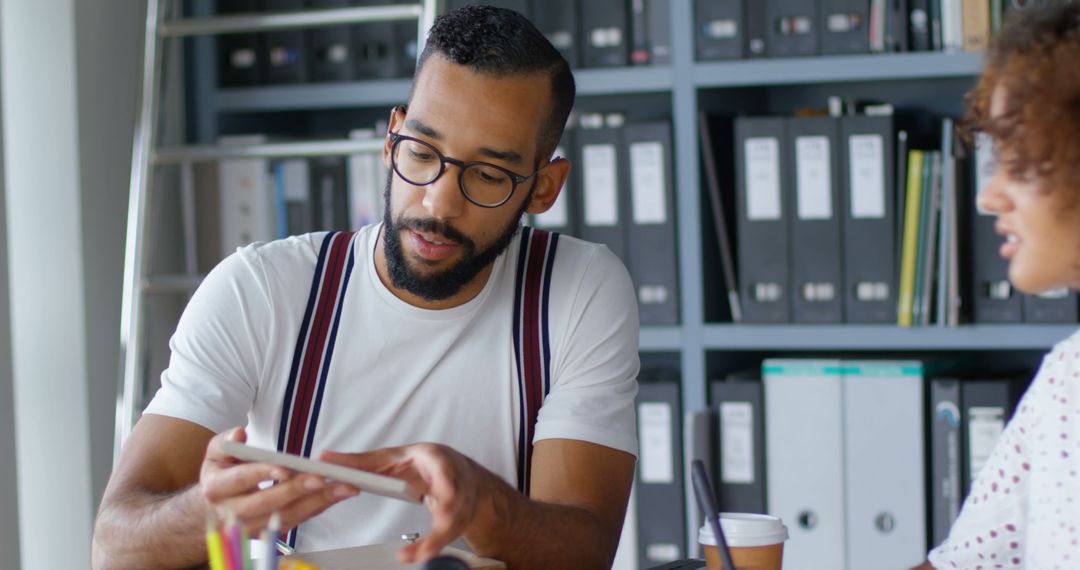 Professional Staff Collaborating in Office on Technology Project