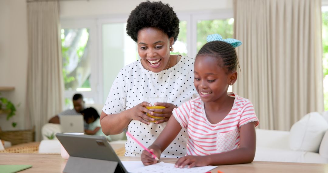 Mother and Daughter Enjoying Educational Tablet Activities Together